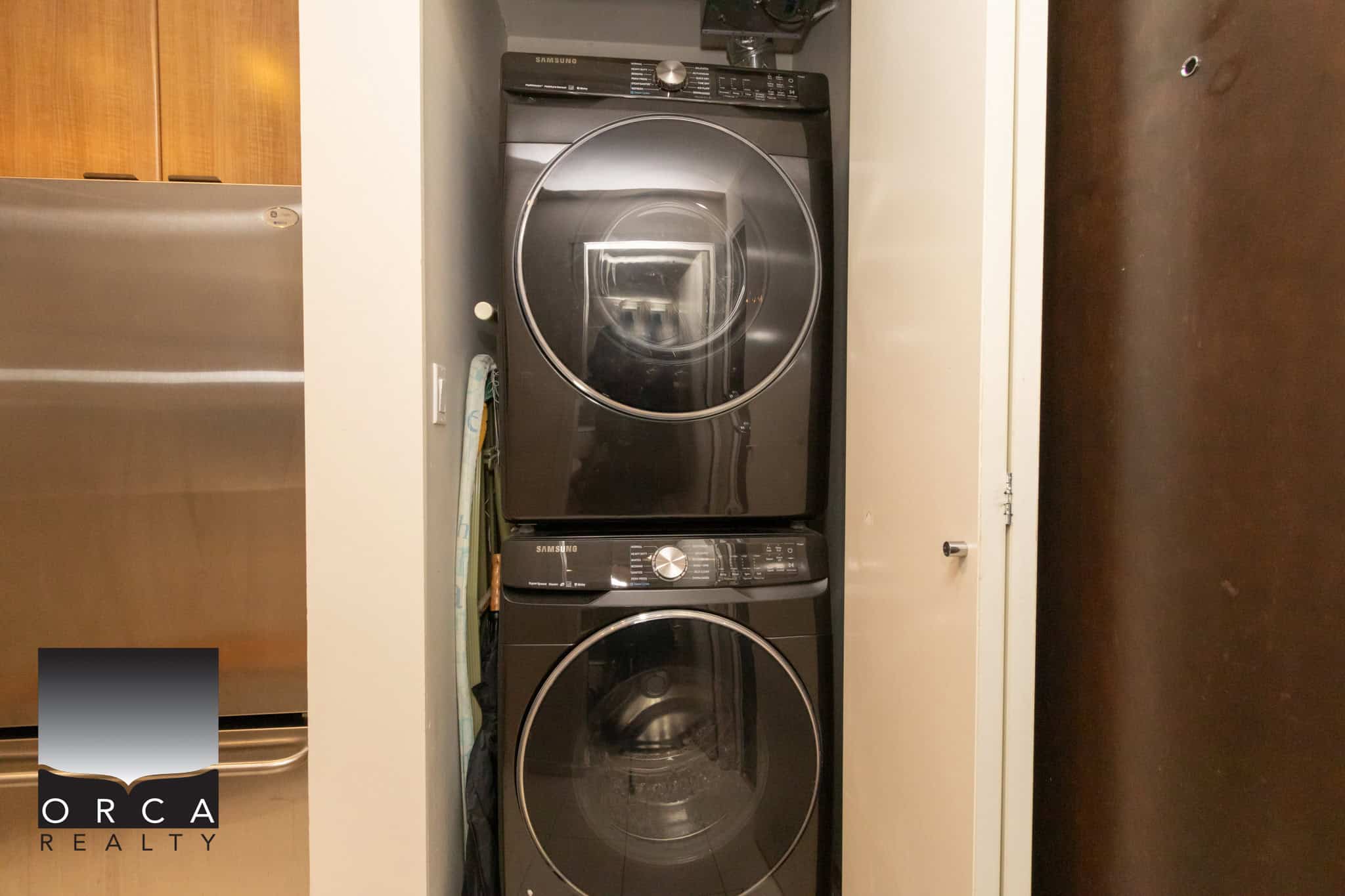 High-efficiency Samsung washer and dryer set in laundry closet with space-saving design, ideal for modern homes in Vancouver, B.C., featuring durable appliances for easy laundry management.