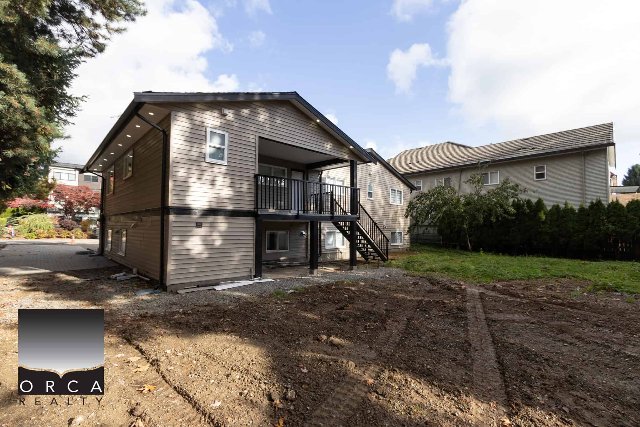 Spacious two-story residential home with a backyard, modern siding, and a deck area, located in a family-friendly neighbourhood in Vancouver, BC. Perfect for real estate investors and families.