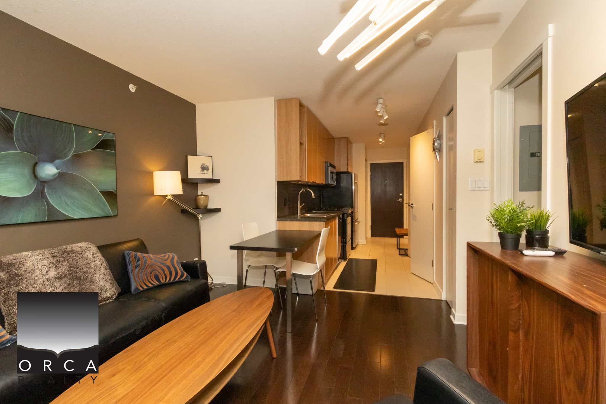 Modern Vancouver apartment interior with open-concept living room, stylish kitchen, and contemporary decor, perfect for downtown living and real estate investment.