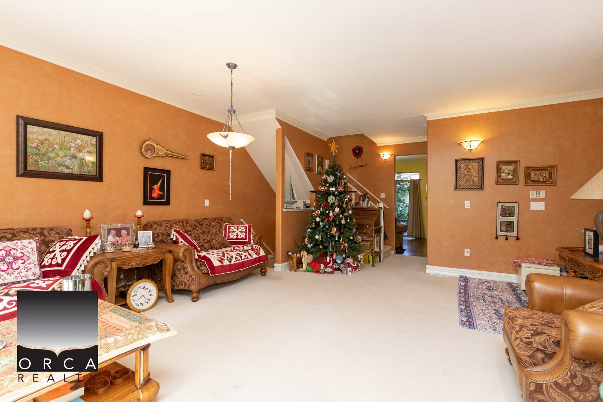 13 Cozy living room with warm orange walls, festive Christmas decorations, and vintage furniture, showcasing a welcoming home interior ideal for families and holiday gatherings.