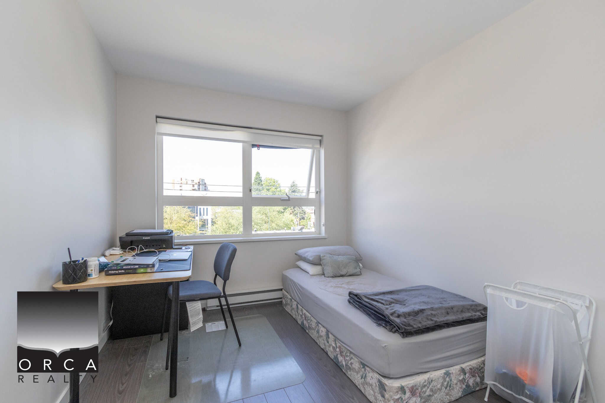 Cozy bedroom with natural light, simple decor, and essential furniture, perfect for students or professionals seeking a comfortable living space near Vancouver.