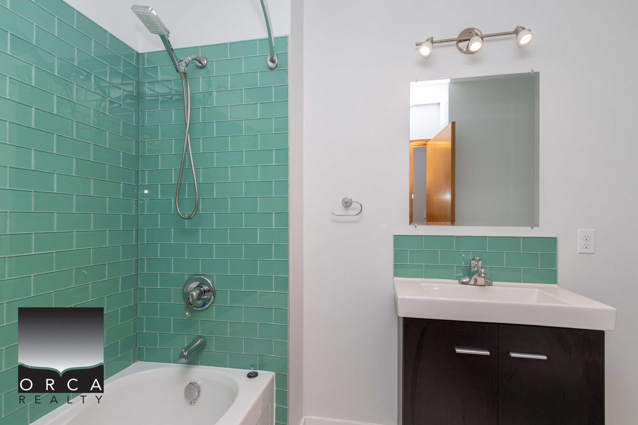 14 Bright bathroom with green subway tile in bathtub and shower area, modern vanity with mirror, perfect for Vancouver real estate listings.