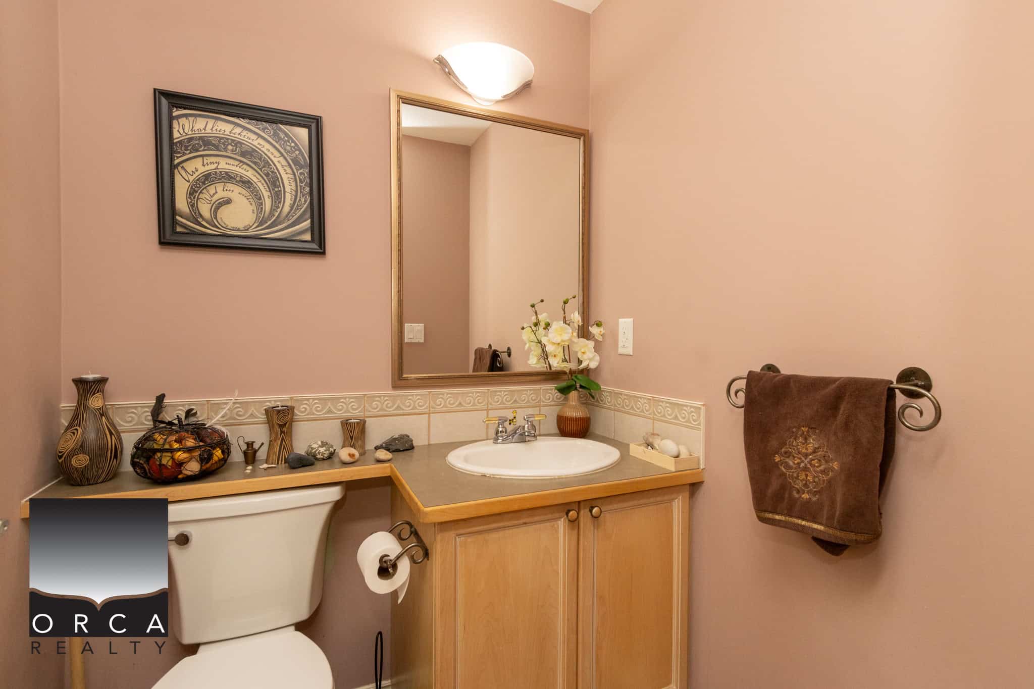 14 Bright bathroom vanity with beige walls, decorative accessories, and elegant decor, ideal for showcasing Vancouver Island homes listed with Orca Realty Inc.