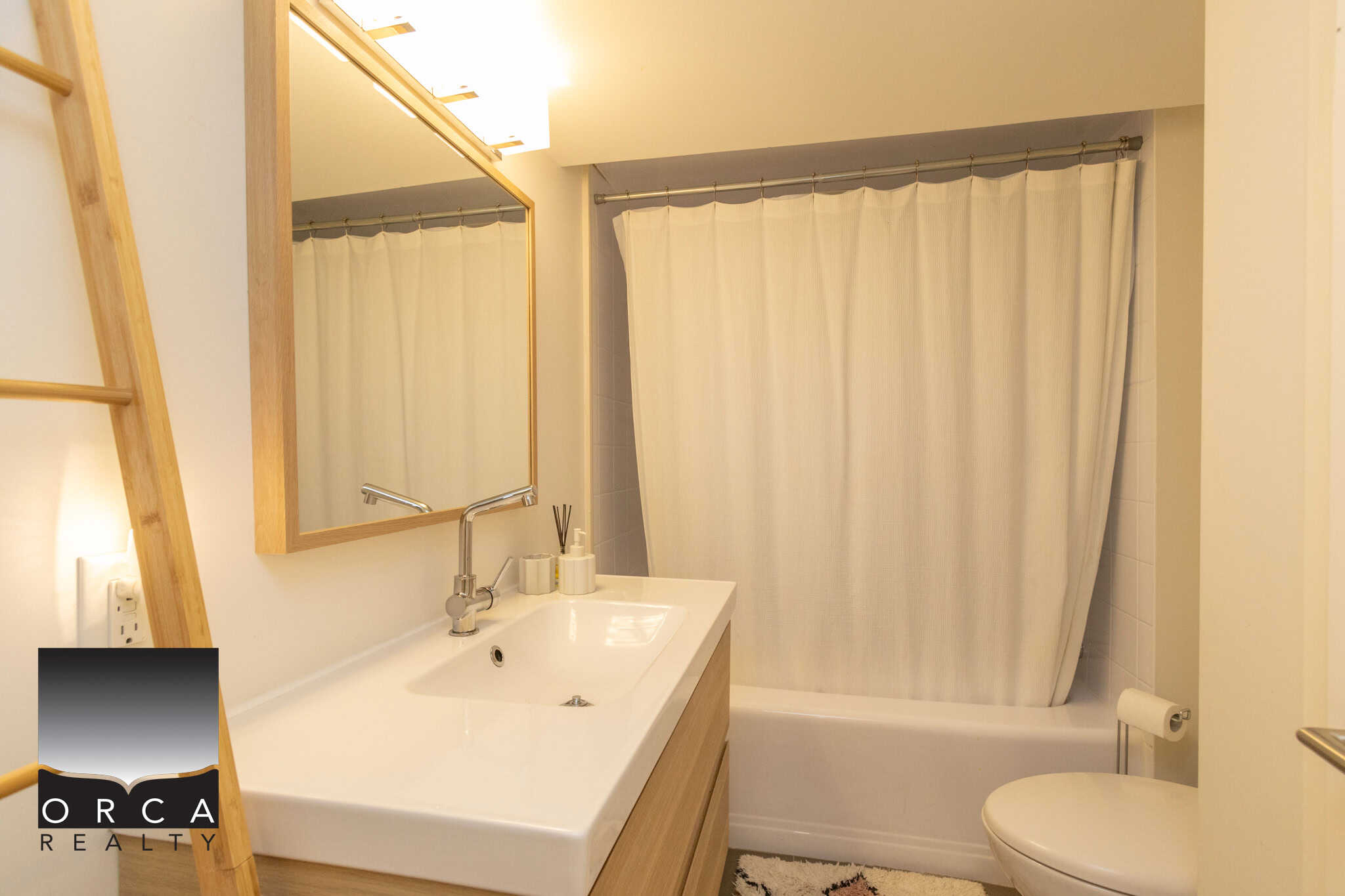 15 Modern bathroom with minimalist design, natural wood accents, and clean white fixtures; perfect for Vancouver Island homes, featuring a bathtub, shower curtain, and contemporary lighting.