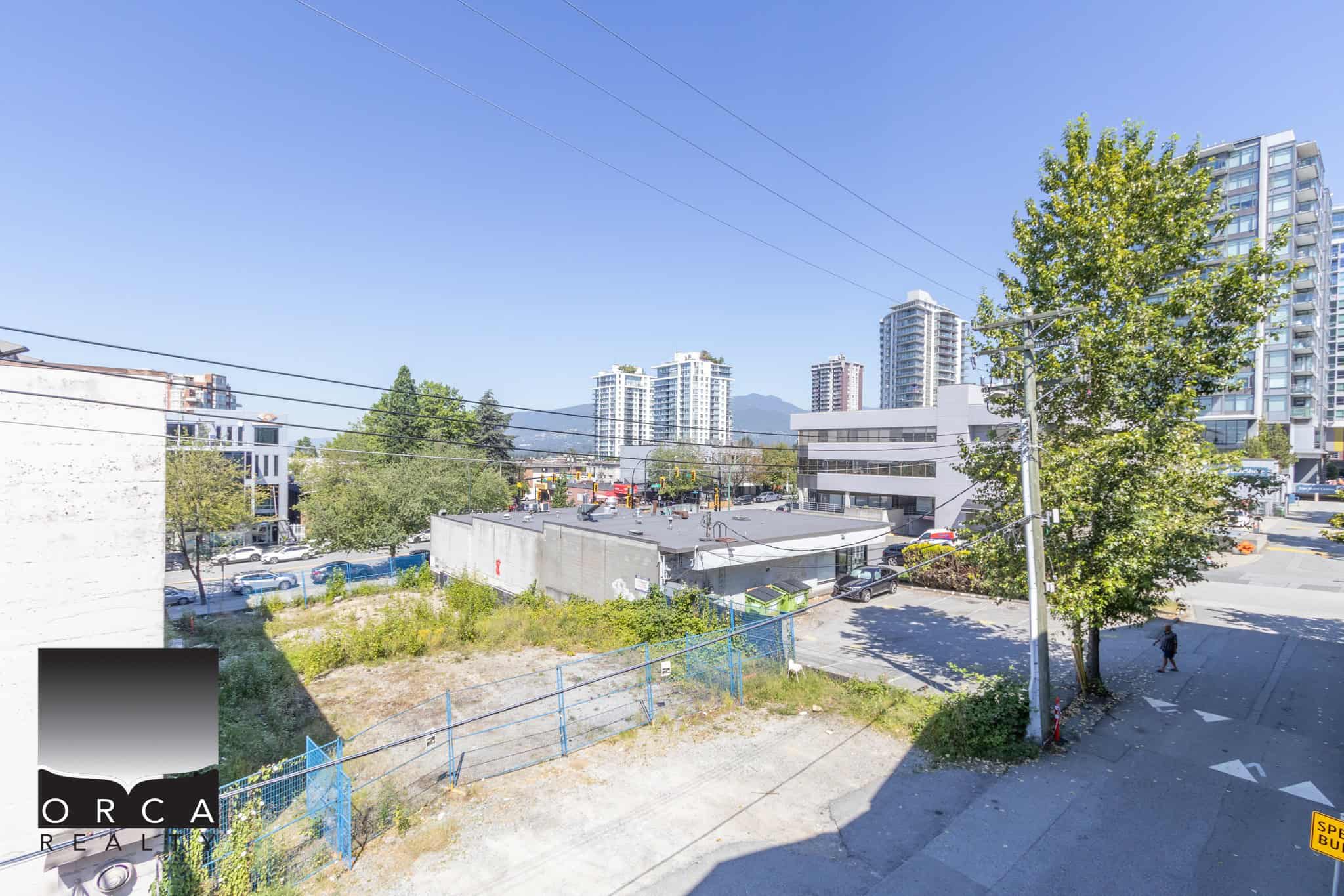 Urban lot available for commercial or residential development in Vancouver, near high-rise condos and amenities, with city and mountain views, ideal for investment.