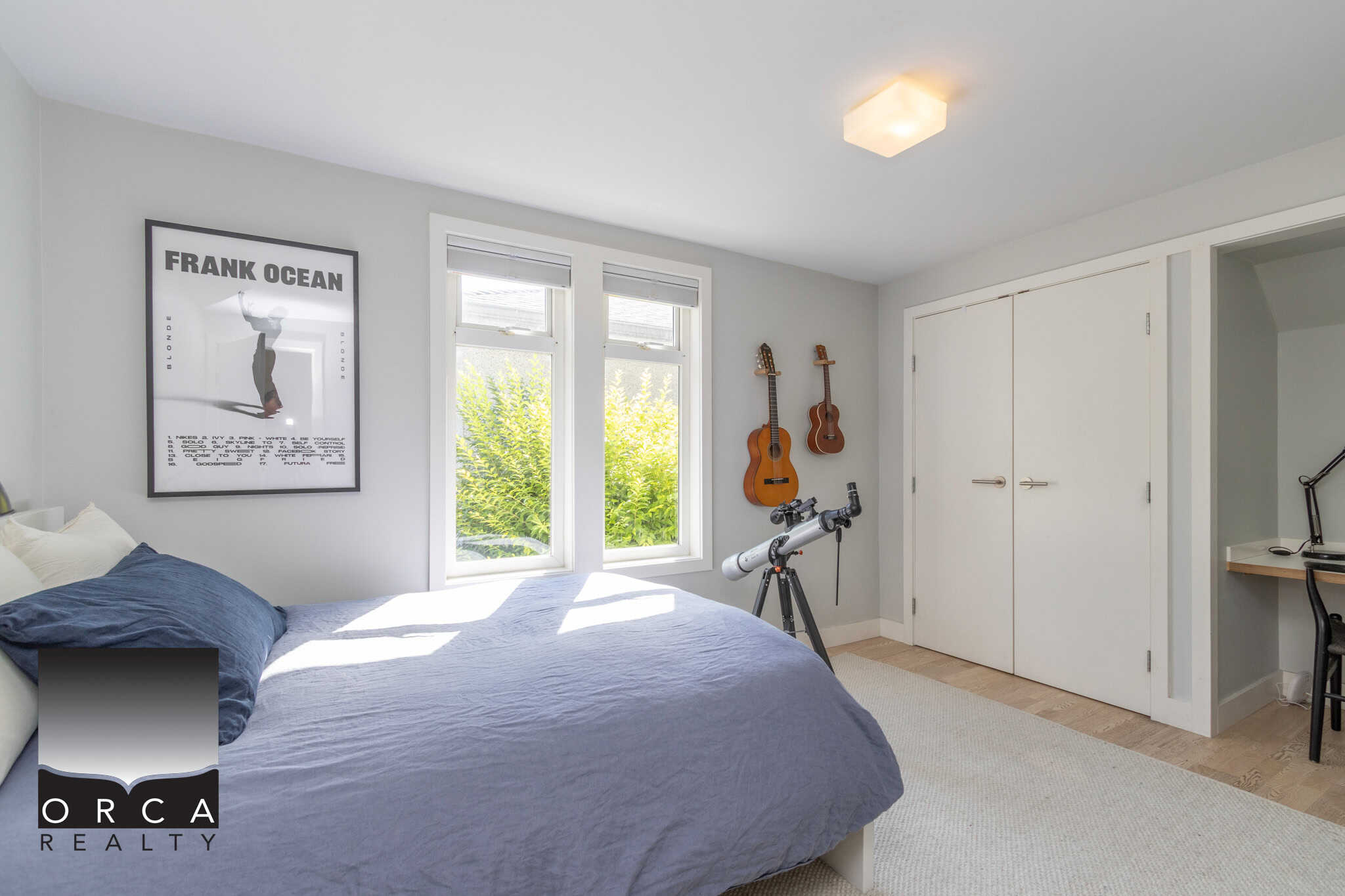 17 Bright bedroom with large windows, modern decor, and musical instruments, perfect for family living or investment property, offered by Orca Realty Inc.