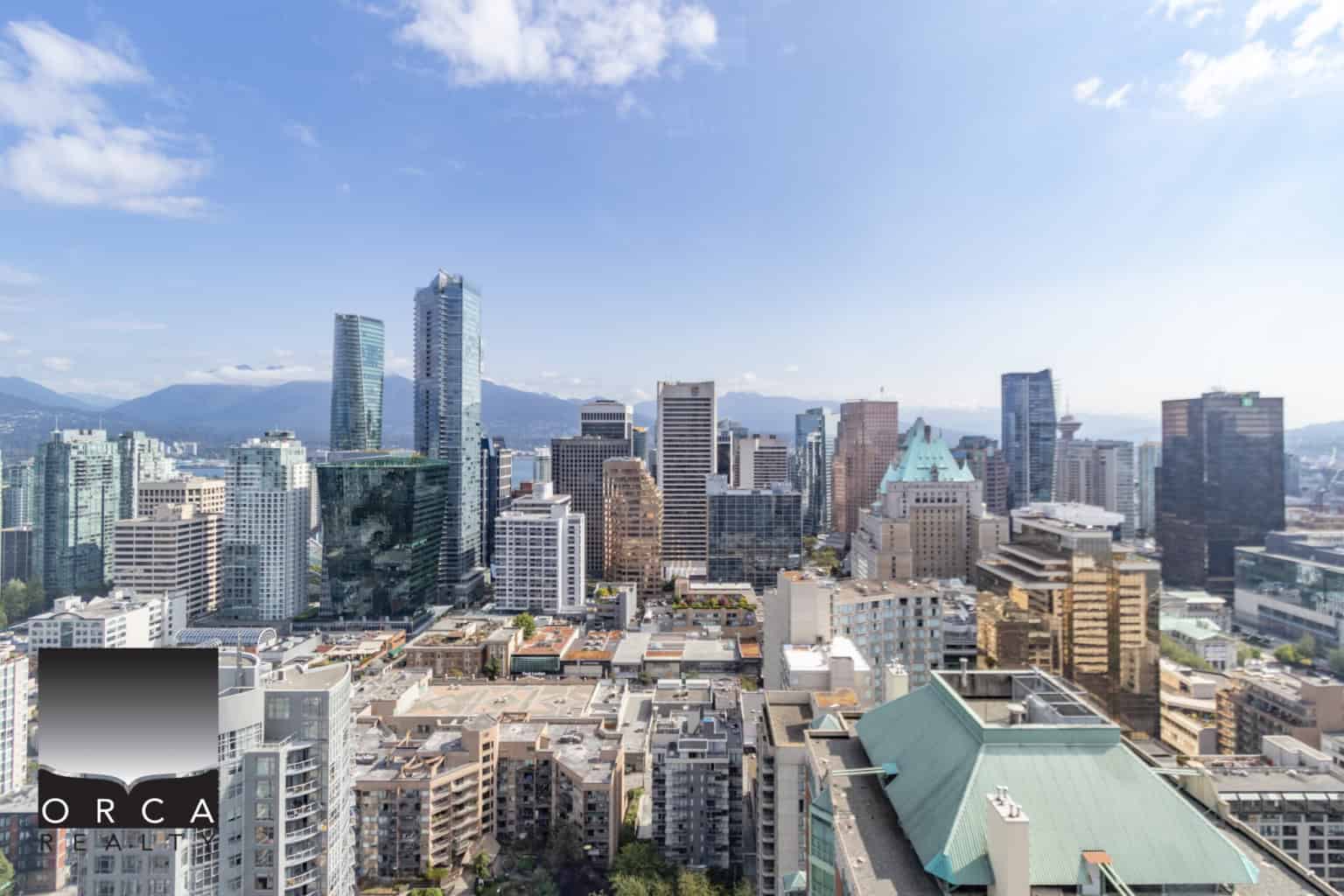 Vibrant Vancouver city skyline with modern skyscrapers and mountain backdrop, showcasing the urban real estate landscape in British Columbia.