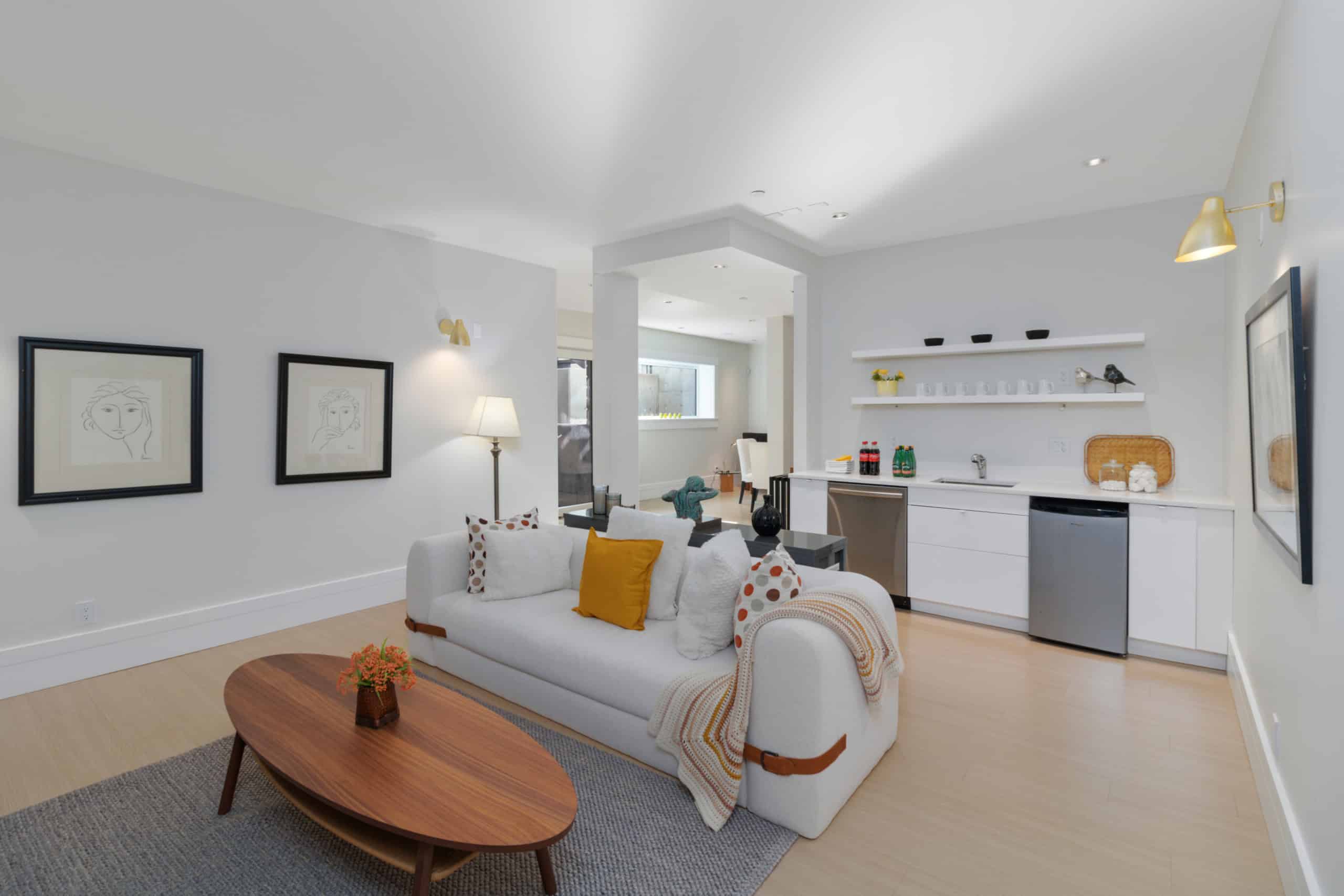 Modern interior of a stylish waterfront condo in Victoria, BC with open living space, contemporary furnishings, and a well-equipped kitchenette, perfect for luxury real estate and property rentals in Vancouver Island.