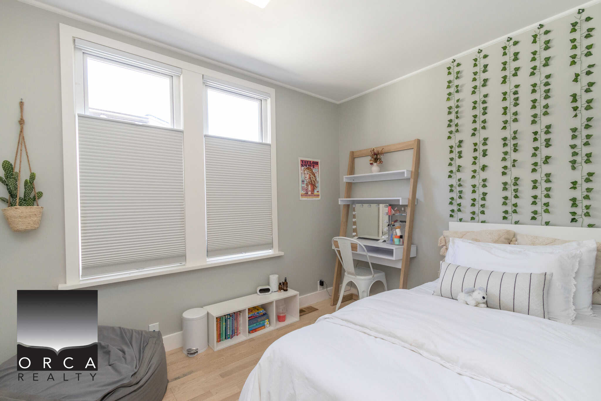 19 Bright bedroom with light grey walls, large windows with white blinds, cozy bed with white linens, and decorative green plant wall mural, showcasing a modern and serene interior design.