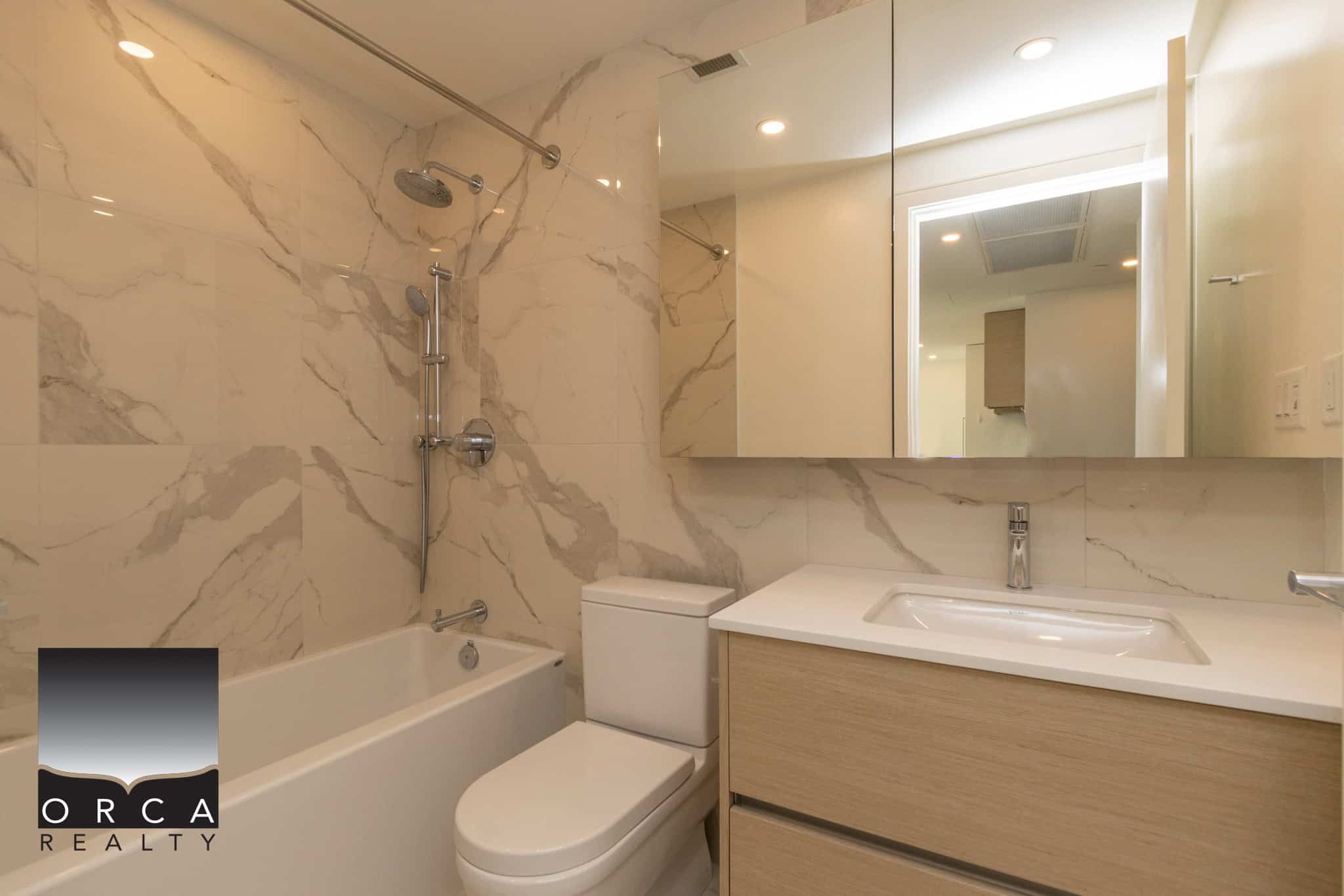 Luxurious modern bathroom with marble walls, sleek vanity, and high-end fixtures in a contemporary home – perfect for buyers seeking upscale real estate in Canada.