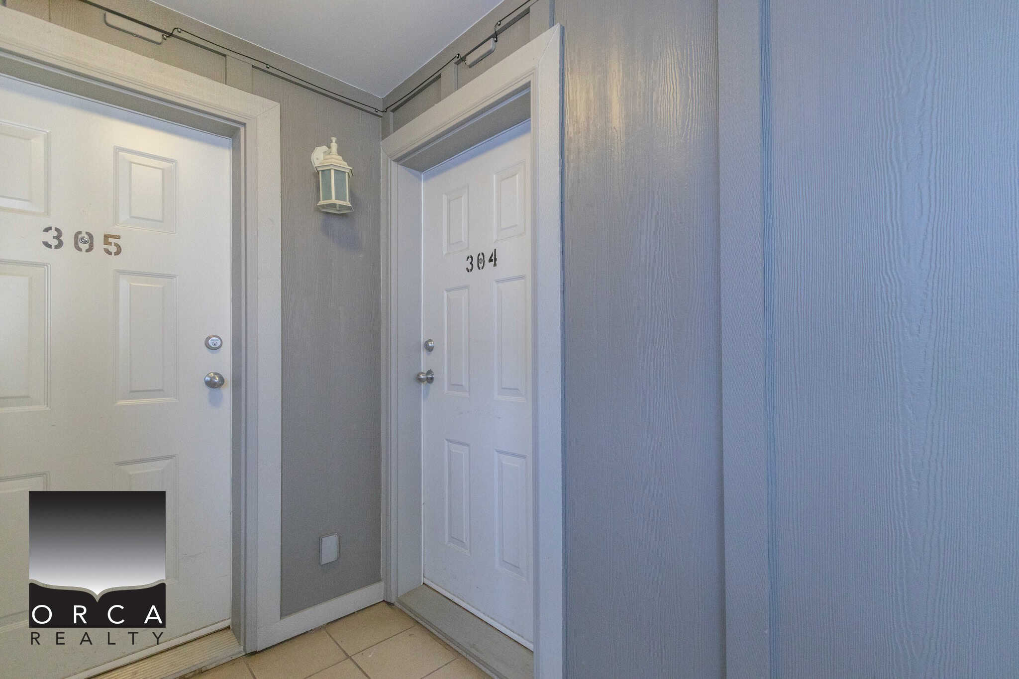 Bright entranceway of a modern Vancouver condo apartment with neutral tones, sleek interior design, and quality finishes showcasing the expertise of Orca Realty Inc.
