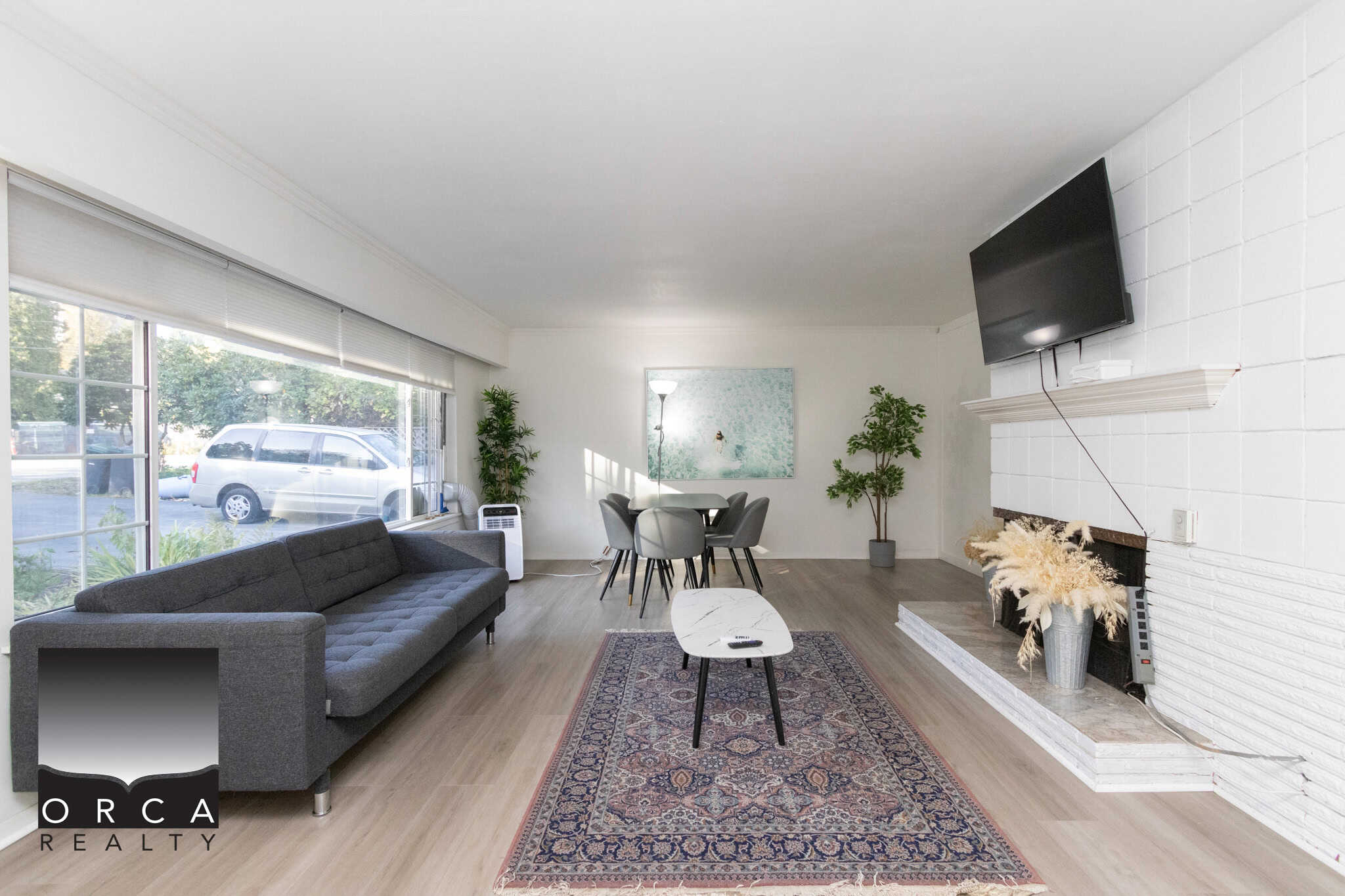 2 Bright spacious living room in Vancouver with large windows, modern furniture, hardwood floors, and a cozy fireplace, ideal for home staging and real estate listings.