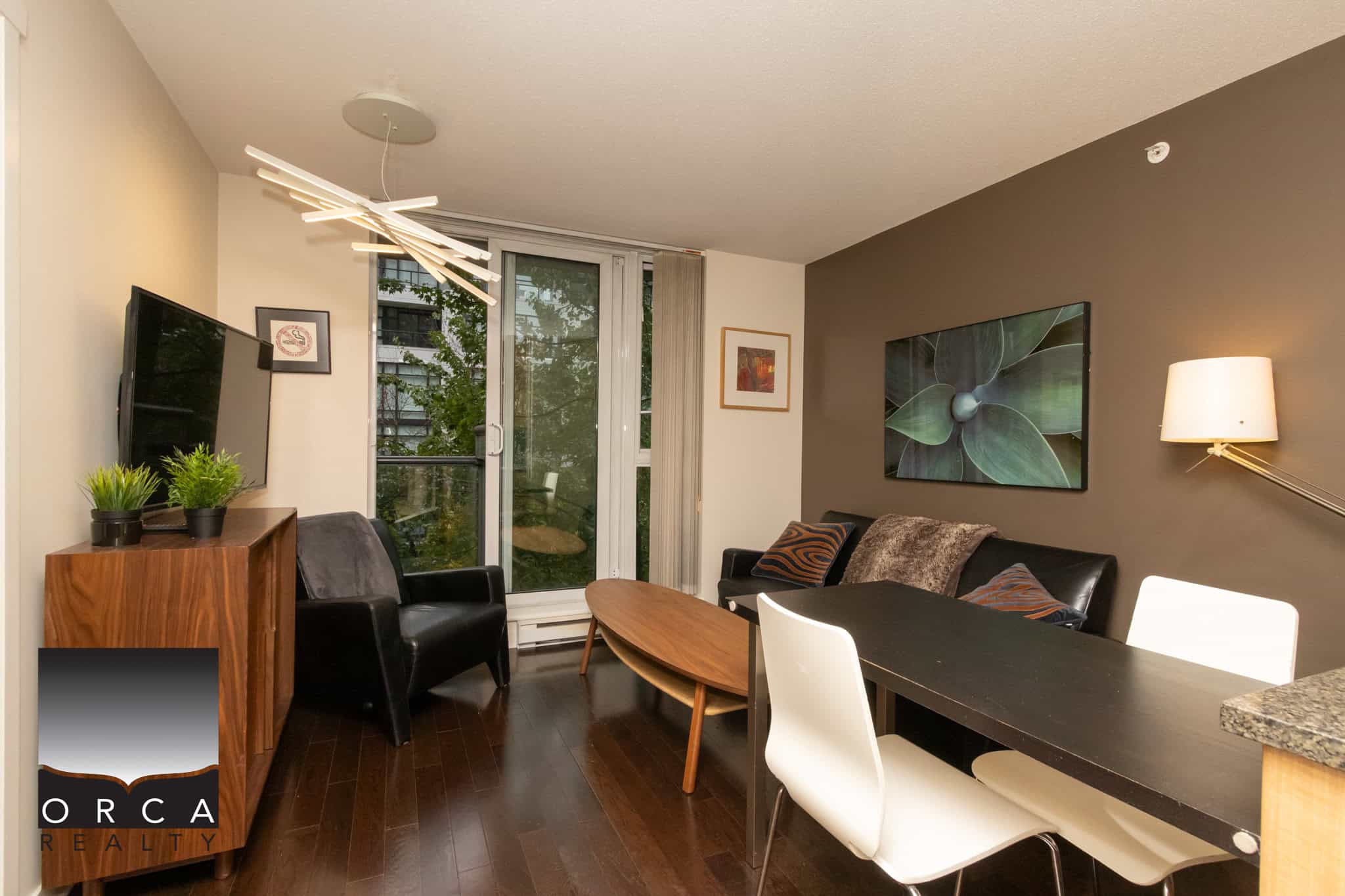 Bright and modern living room in an Orca Realty property featuring stylish decor, natural light, and hardwood floors, perfect for comfortable living and optimal real estate showcasing.