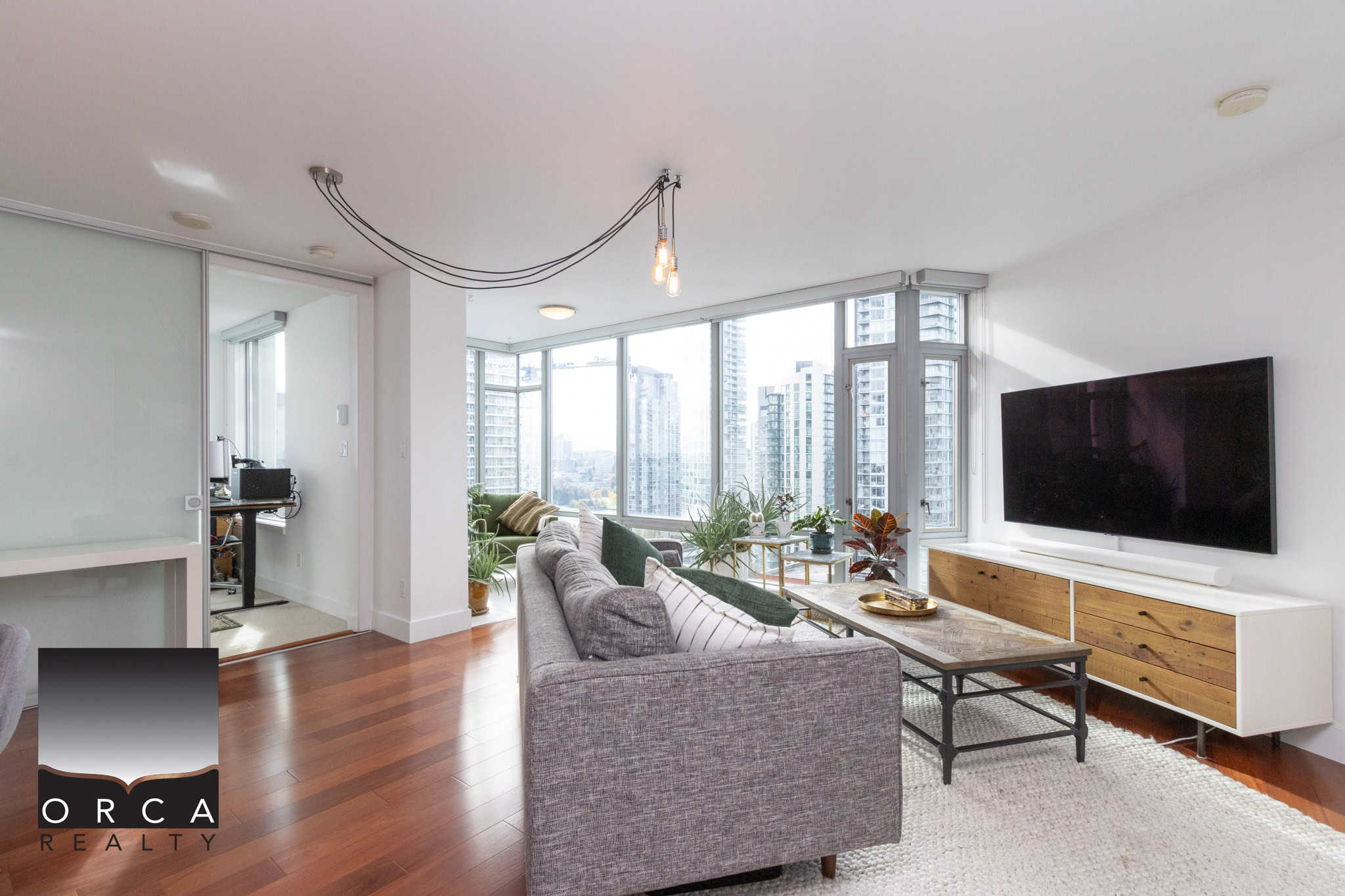 Modern Toronto high-rise condo living with bright living room, city skyline views, and contemporary interior design. Ideal for homebuyers seeking vibrant downtown Vancouver real estate.