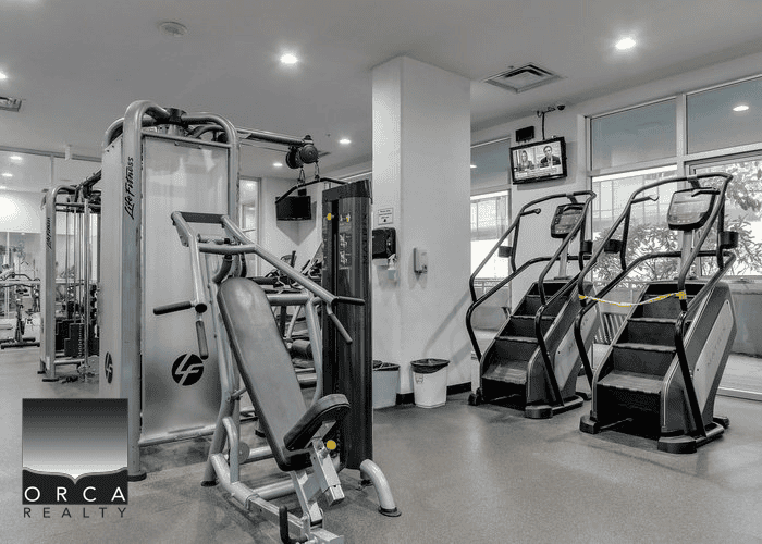Passenger treadmill and gym equipment in fitness centre at Orca Realty Inc. fitness area.