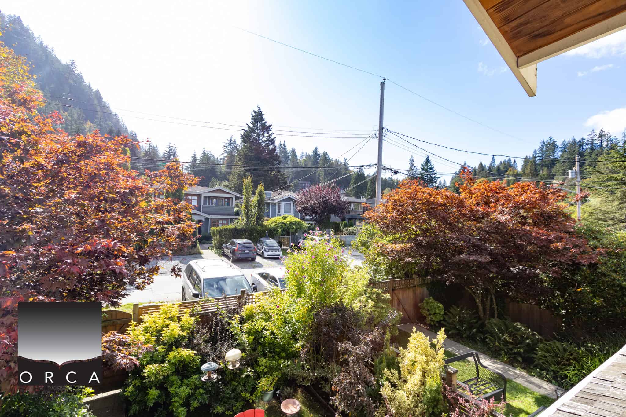 20 Lush garden view from a residential balcony with vibrant trees and neighborhood houses in Vancouver, British Columbia, showcasing outdoor space, scenic beauty, and the local real estate environment.