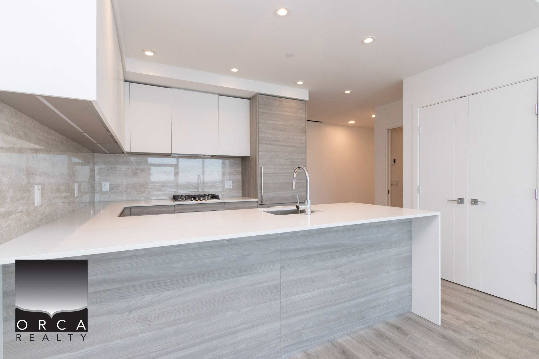 20 Modern minimalist kitchen with light wood cabinetry and white quartz countertops, featuring sleek appliances and contemporary design—perfect for Vancouver real estate listings.