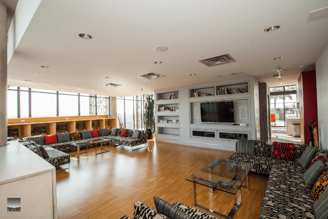 Modern living room with large windows, stylish sofas, and contemporary decor, ideal for showcasing Toronto real estate listings and interior design.