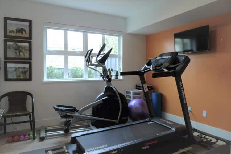 Treadmill and elliptical exercise equipment in home gym for sale in Vancouver, BC.
