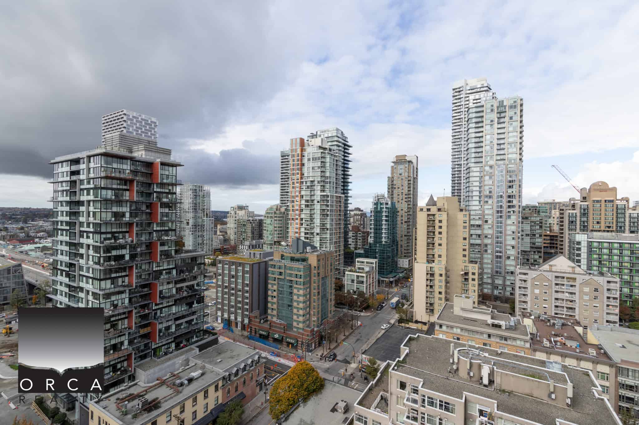Vibrant Vancouver city skyline featuring modern high-rise condominiums and residential buildings in Downtown Vancouver, offering premier real estate opportunities with Orca Realty Inc.