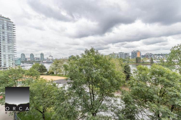 Spacious Vancouver urban apartment with scenic river views and lush greenery, perfect for modern living in a prime downtown location.