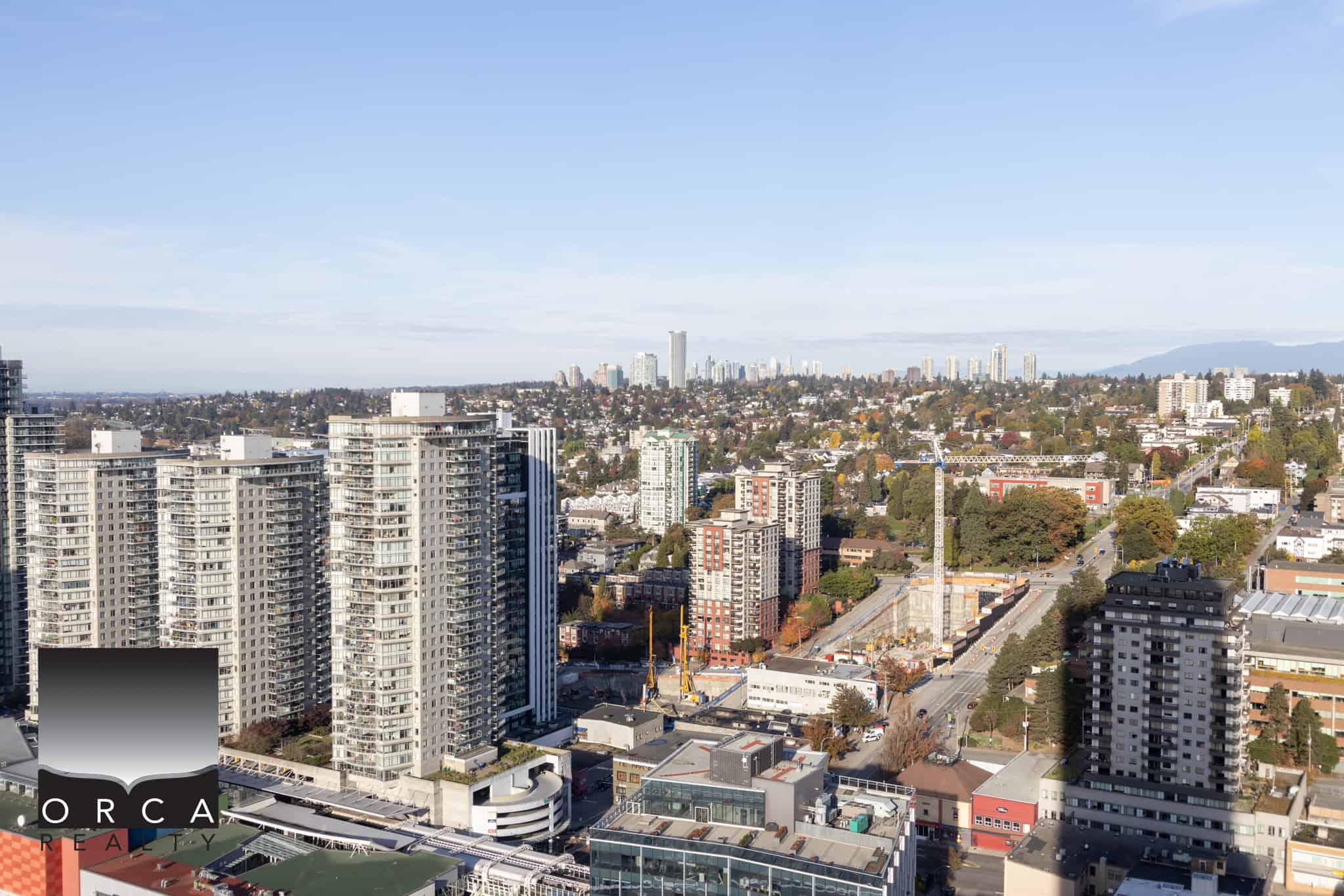 24 Modern Vancouver skyline view showcasing high-rise condo buildings, urban landscape, and lush greenery, ideal for those interested in Vancouver real estate and property investment.