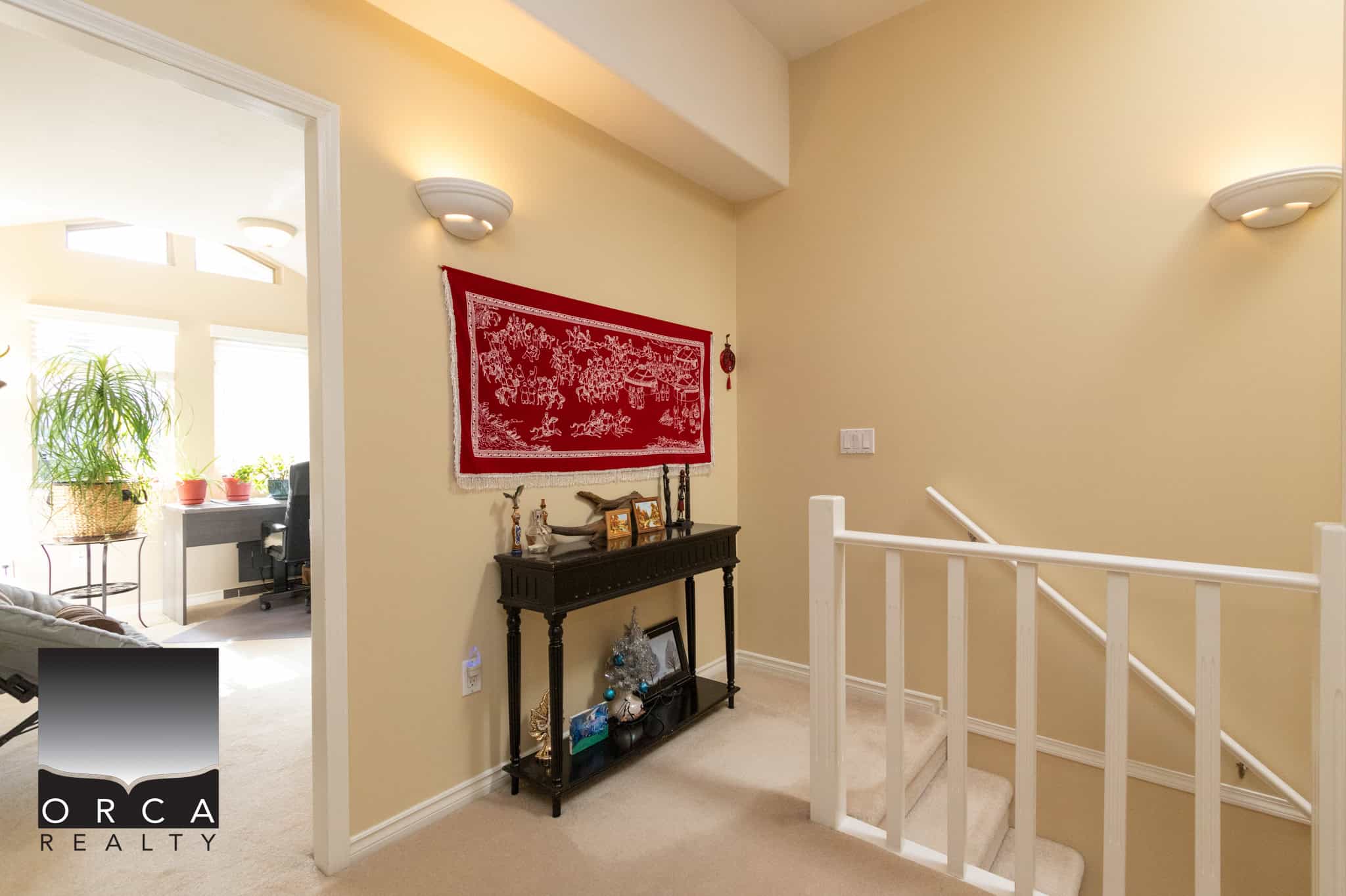 25 Cozy upstairs landing with decorative wall art and elegant staircase in a modern home for sale by Orca Realty Inc.