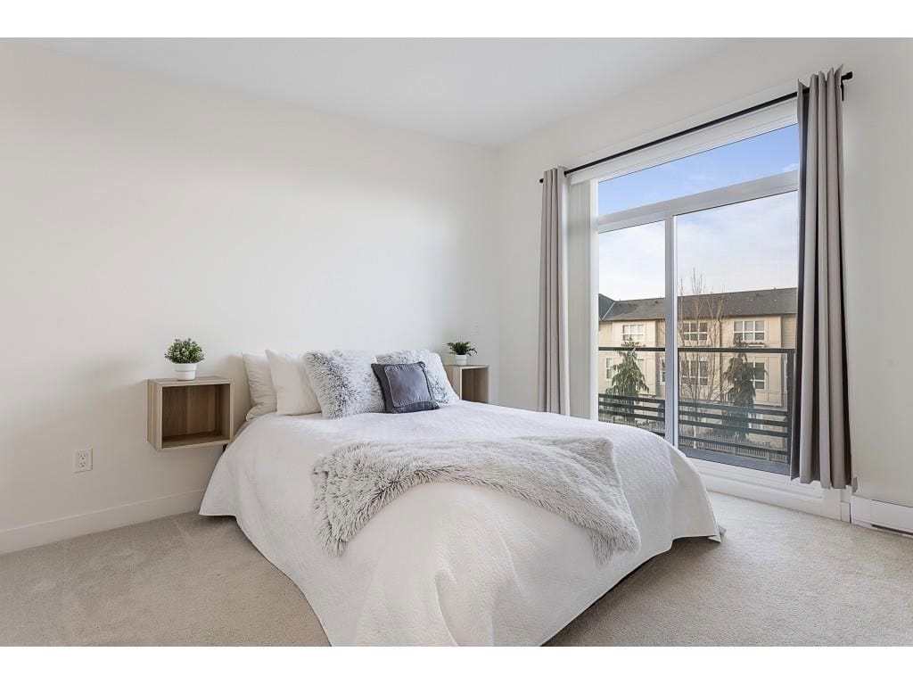 Modern bedroom with large window and balcony access, featuring minimalist decor and neutral tones for a cozy, contemporary feel.