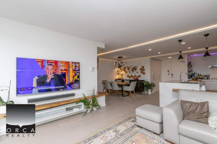 Modern open-concept living room and dining area featuring sleek design, contemporary furniture, and stylish lighting, perfect for Vancouver real estate buyers.