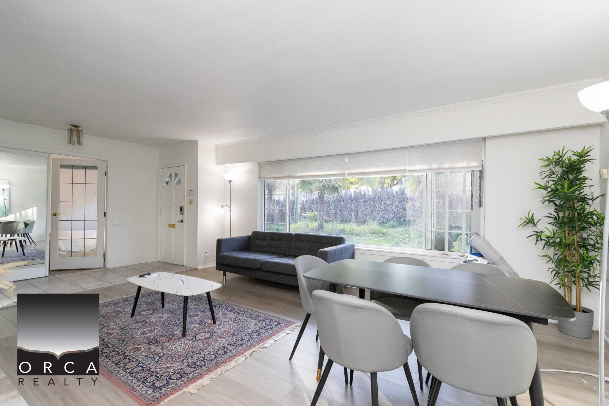 3 Spacious living room with large windows, modern furniture, and a cozy ambiance, perfect for family gatherings and relaxation in Vancouver.
