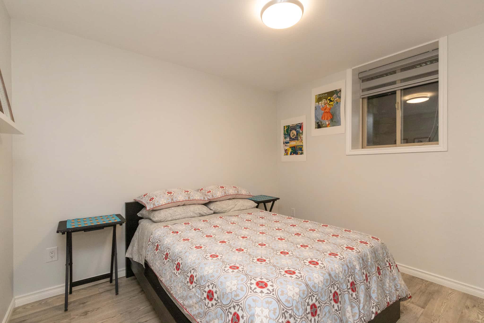 30 Cozy bedroom with a double bed, modern decor, and natural light - ideal for Vancouver Island living, featuring neutral tones and ample space.