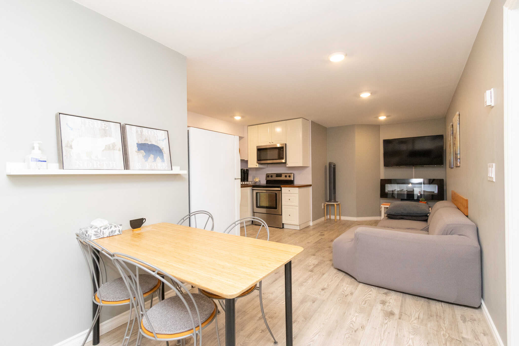 33 Bright open-concept living area with modern kitchen, cozy seating, and entertainment setup, perfect for relaxing or entertaining in a Vancouver, BC, home listed by Orca Realty Inc.