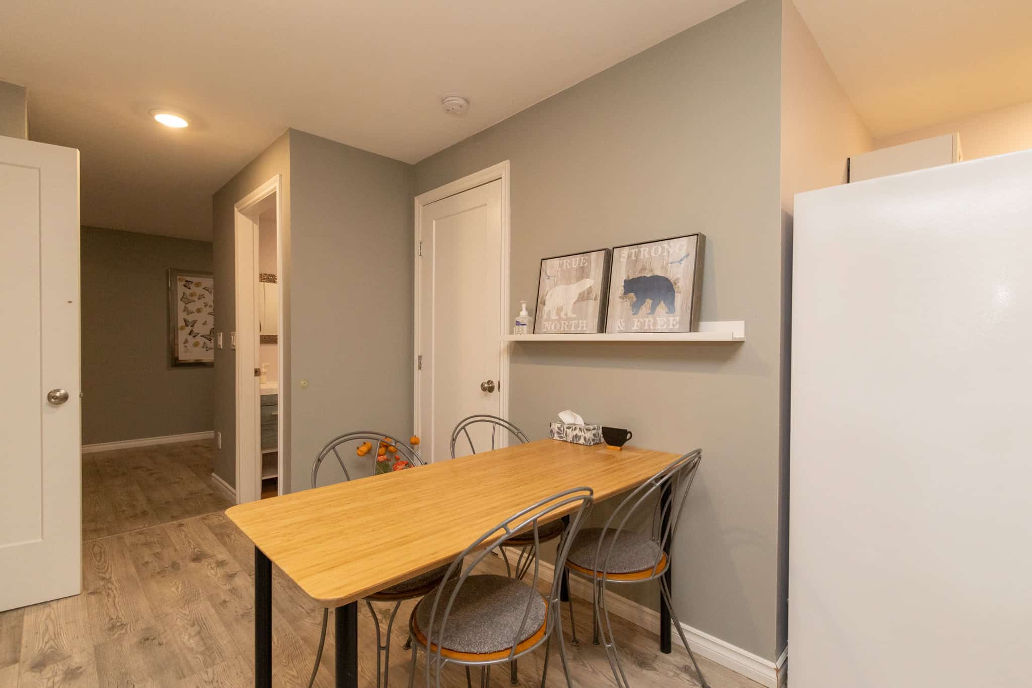 35 Cozy dining area in a modern residential home, featuring a wooden table and metal chairs with soft seating, ideal for family meals or entertaining guests, situated within a stylish, contemporary interior.