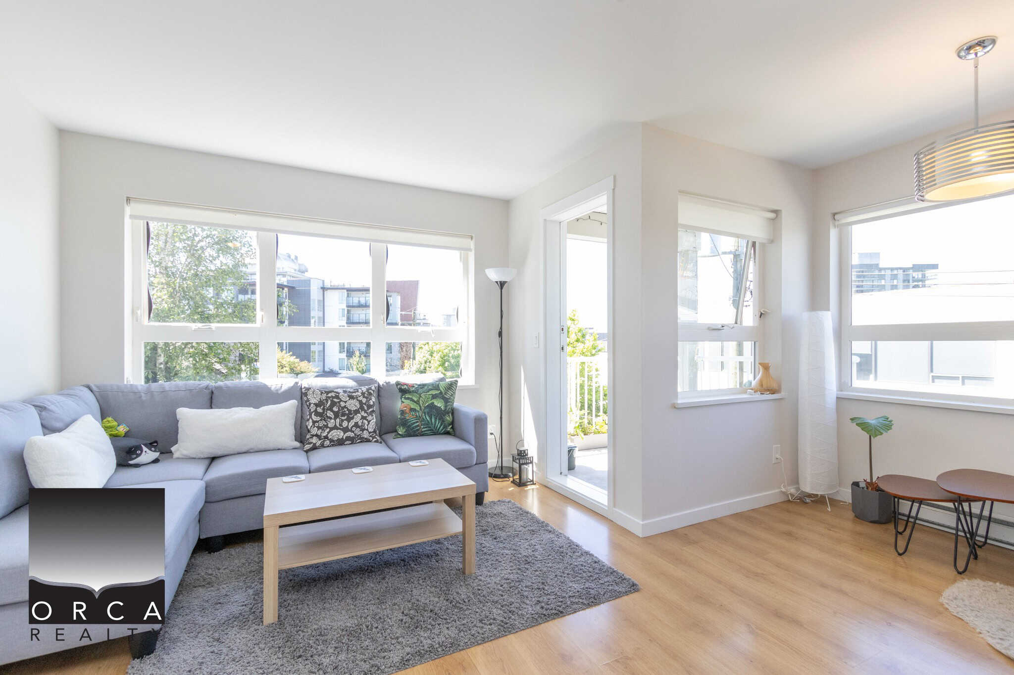 Bright and spacious living room in a modern Vancouver apartment with large windows, natural light, and contemporary decor. Perfect for showcasing Vancouver real estate listings.