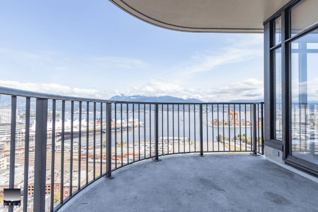 Balcony view overlooking Vancouver harbor and city skyline from a high-rise apartment in Vancouver, British Columbia. Perfect for real estate listings showcasing scenic urban views.