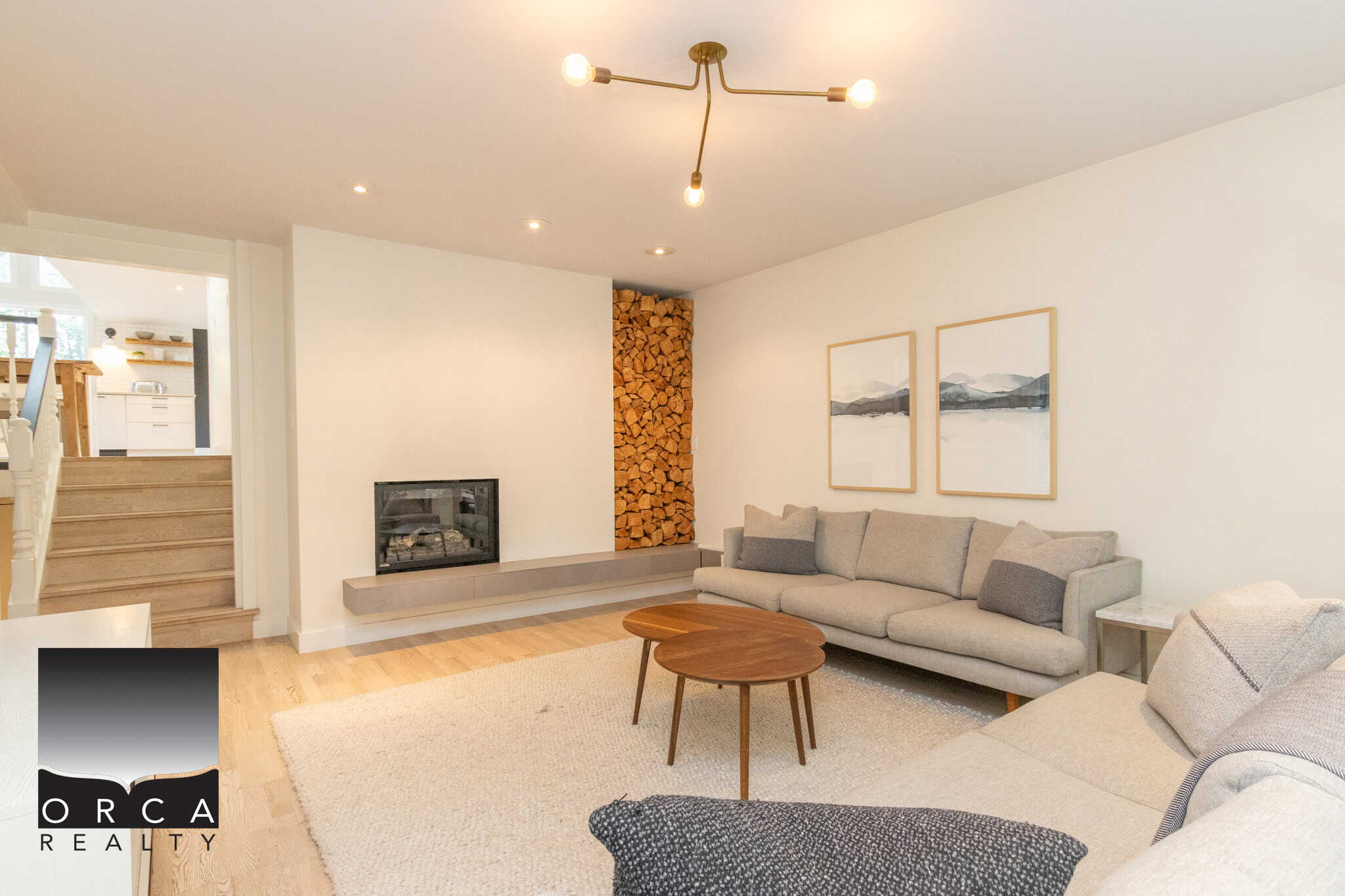 4 Cozy living room with modern fireplace, wood accents, and minimalist decor, ideal for Vancouver Island real estate and homebuyers seeking stylish interior design.