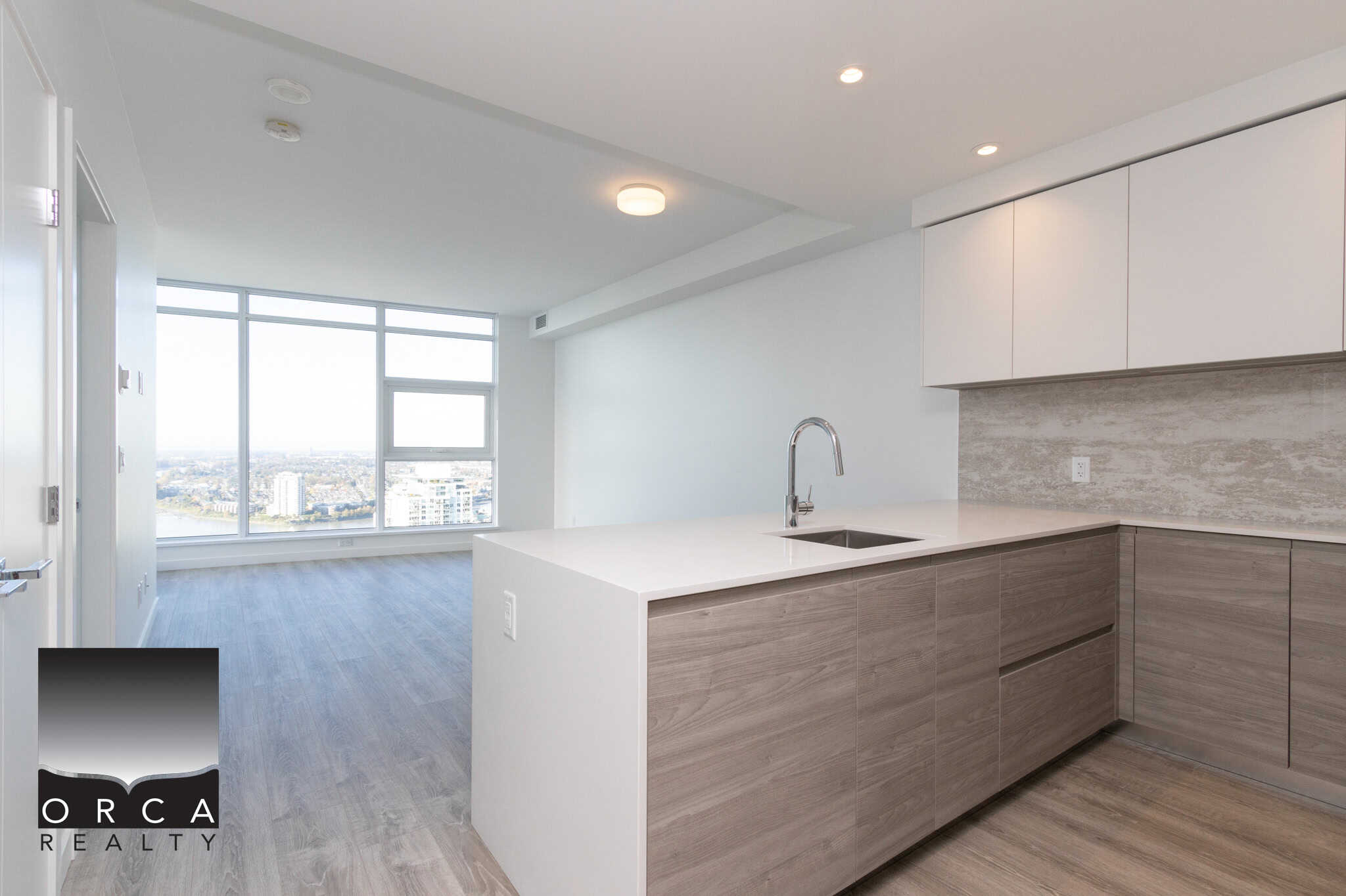 4 Modern open-concept apartment kitchen with high-end finishes and city views in downtown Vancouver. Perfect for buyers seeking luxury condos and real estate investment opportunities.