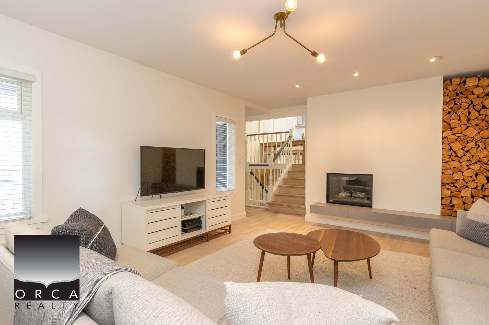 5 Modern living room with neutral tones, featured hardwood floors, contemporary fireplace, and stylish wood accents, perfect for Vancouver Island real estate enthusiasts.