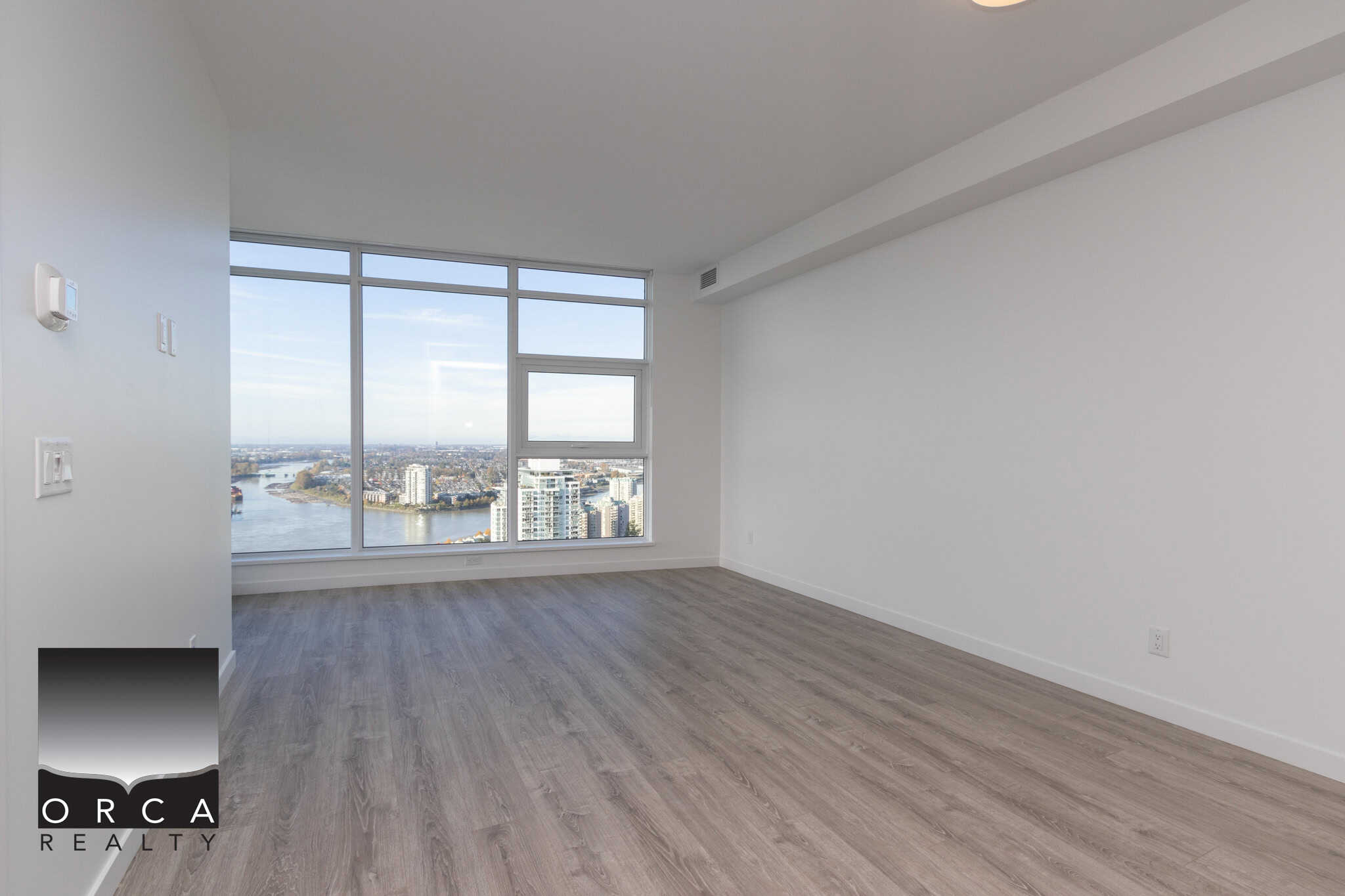 5 Stunning modern high-rise apartment with panoramic city views in Vancouver, featuring large windows, sleek interiors, and contemporary flooring, ideal for luxe urban living.
