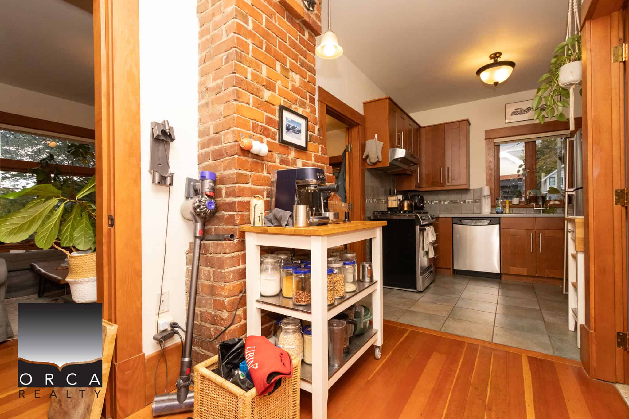 5 Cozy kitchen with warm wooden cabinets, stainless steel appliances, and exposed brick wall, perfect for family living and entertaining in Victoria, BC.