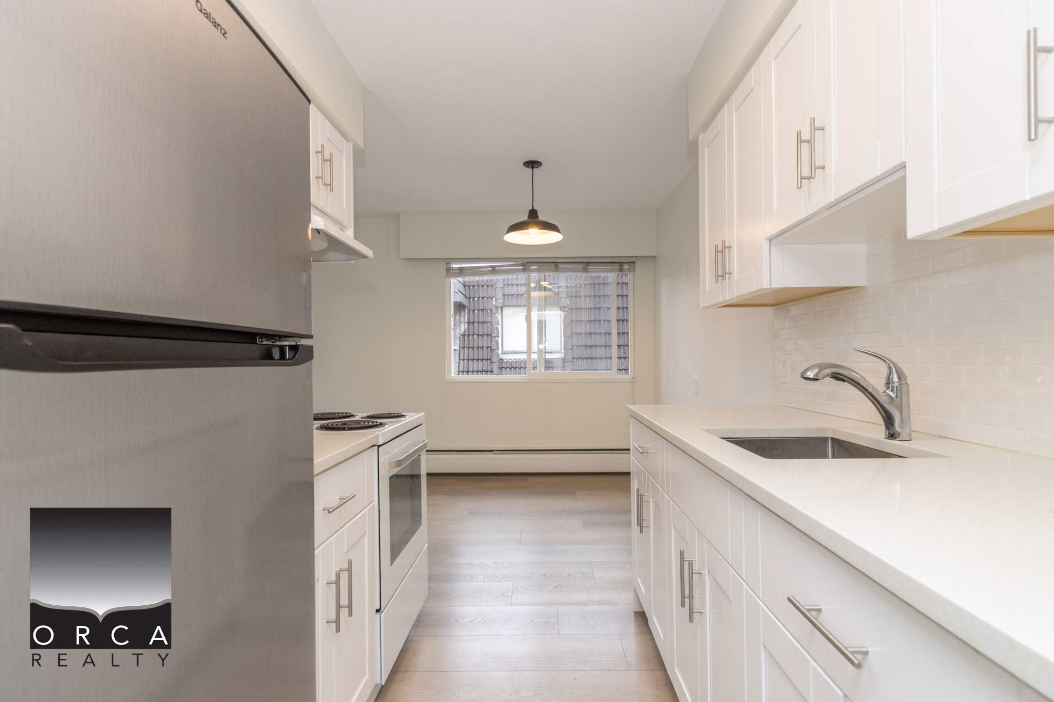 Bright white kitchen with modern cabinetry, stainless steel appliances, and ample counter space, ideal for Vancouver real estate buyers seeking contemporary homes.