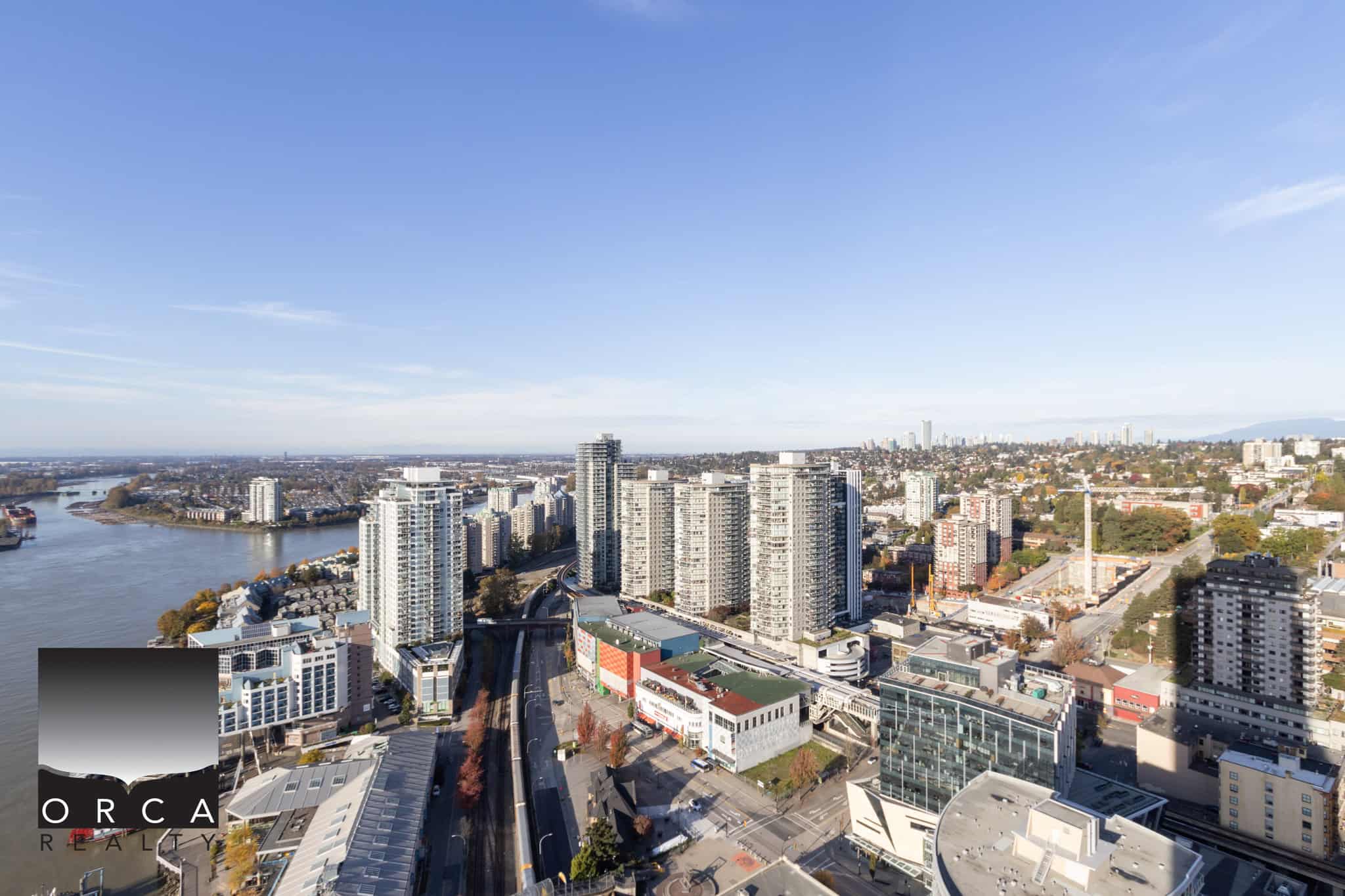 7 Modern Vancouver skyline with high-rise condominiums overlooking the Fraser River, showcasing prime real estate and urban living in the city’s vibrant waterfront area.