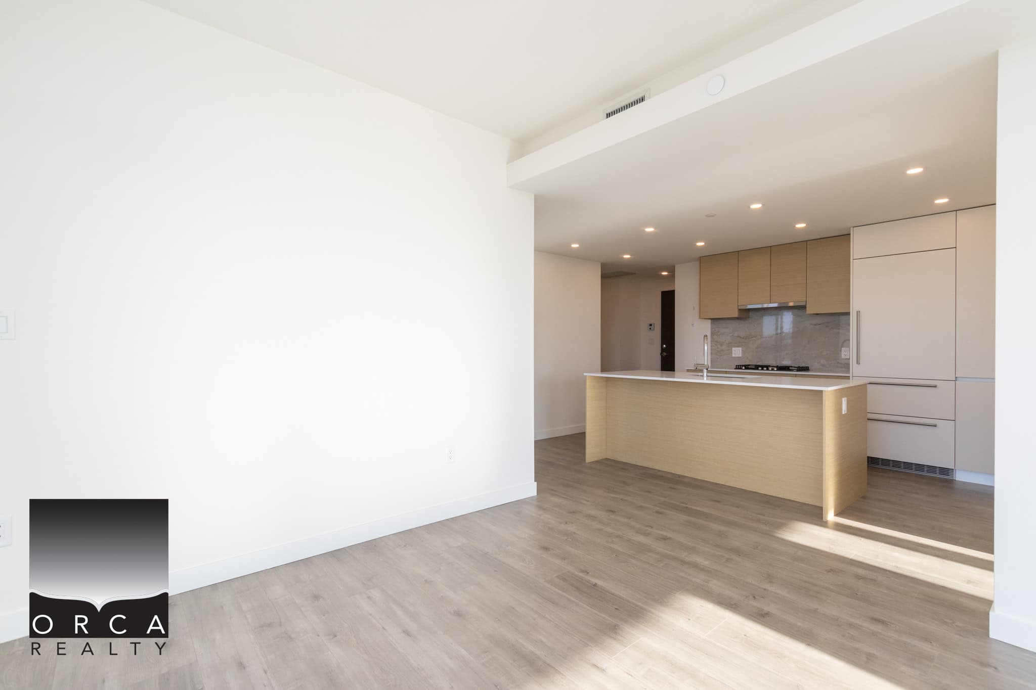 Bright modern kitchen and living space in a contemporary Toronto condo with sleek cabinetry, spacious layout, and abundant natural light, ideal for property buyers and real estate investors.