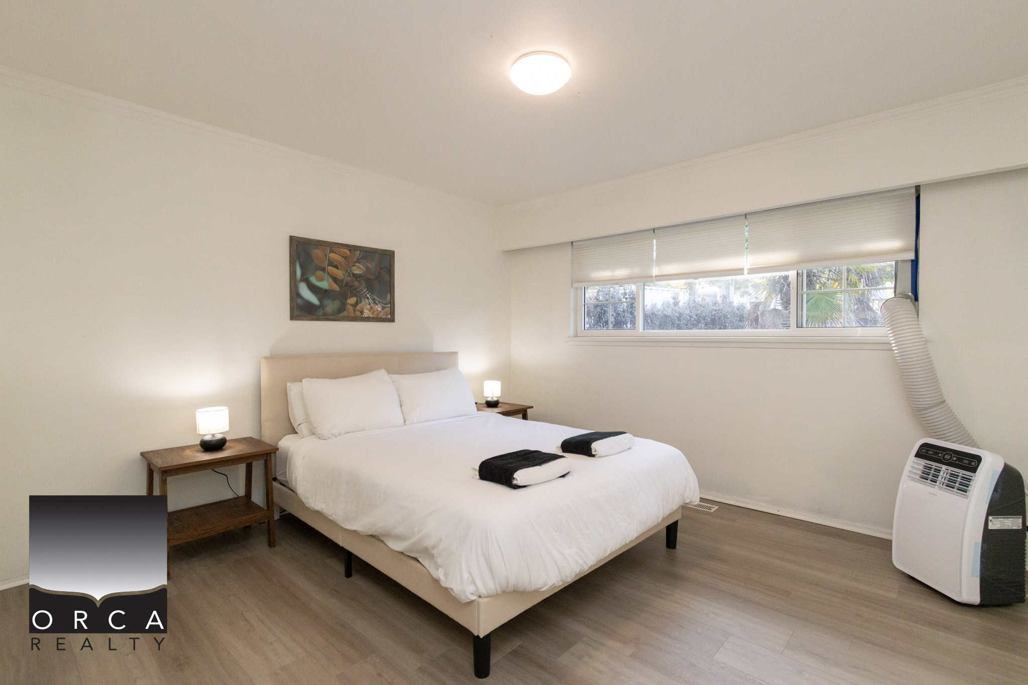 8 Bright modern bedroom with cozy queen-size bed, stylish nightstands, and natural light, ideal for Vancouver or surrounding area real estate listings by Orca Realty Inc.
