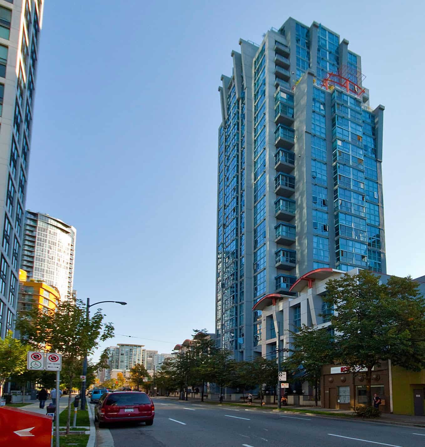 001 Office building with glass facade in Vancouver, BC, showcasing modern high-rise architecture perfect for real estate investments or residential condos, offered by Orca Realty Inc.