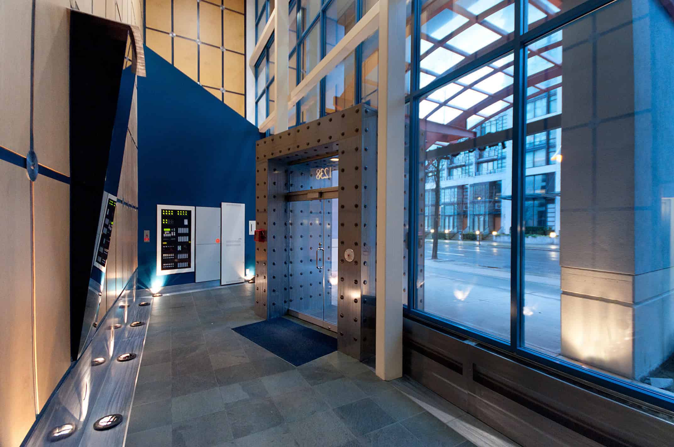 003 Modern commercial building lobby with glass walls, elevator, and sleek interior design showcasing Toronto real estate.