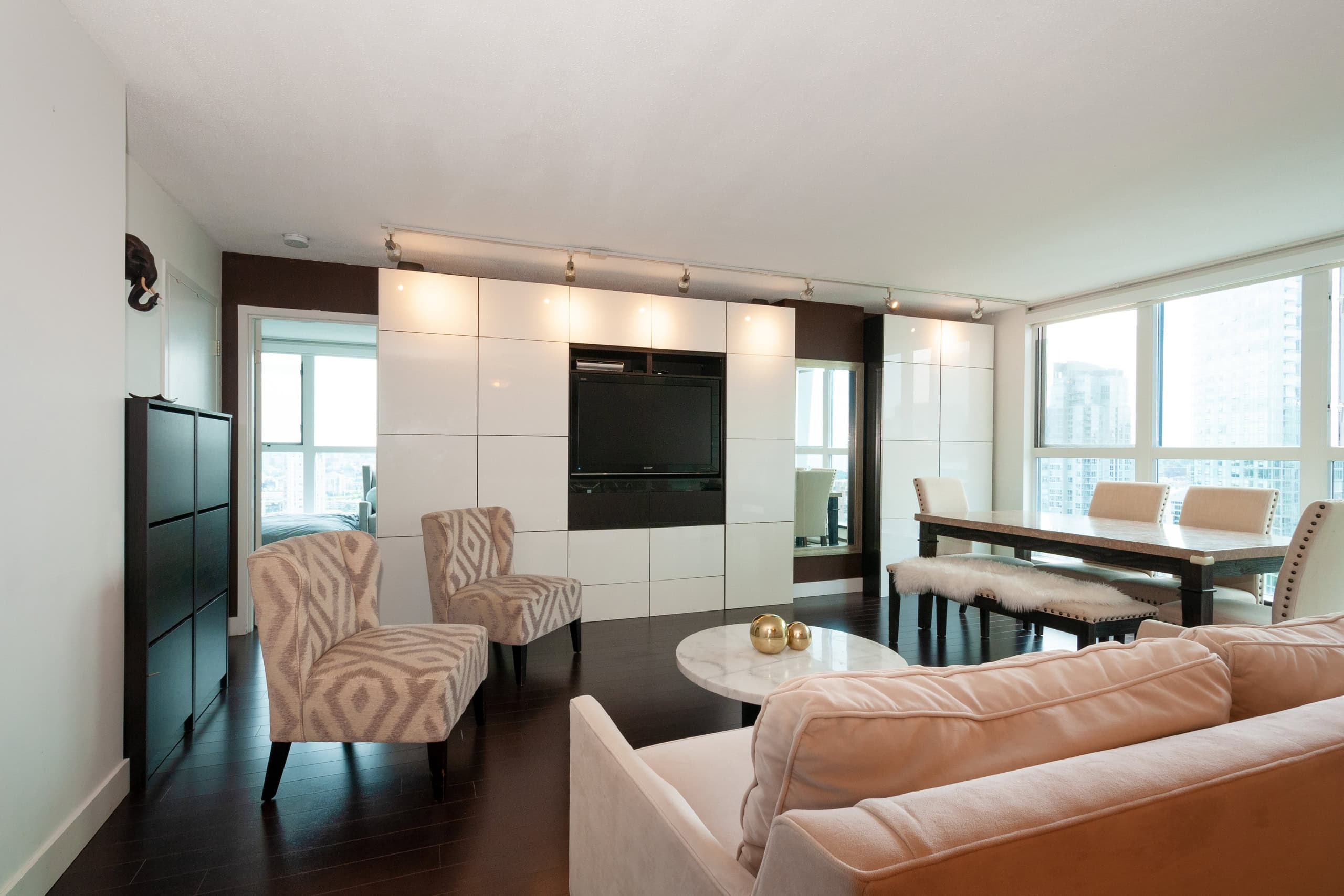 008 Modern living room with large windows, stylish furniture, and built-in entertainment center, featuring a sleek, contemporary design perfect for Vancouver real estate.