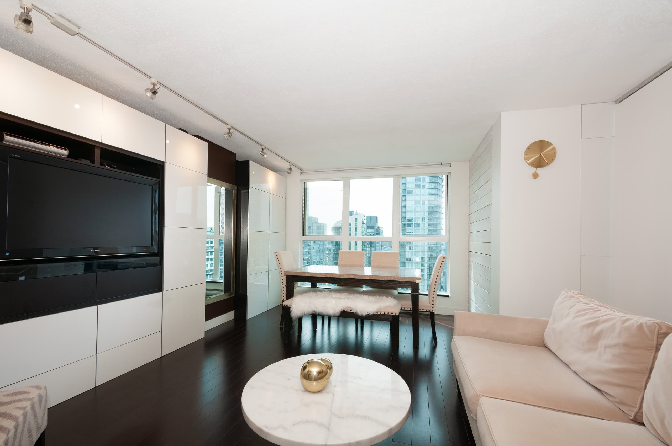 009 Modern downtown Vancouver condo living room with large windows, stylish furnishings, and urban city views, perfect for real estate investment and high-rise apartments.
