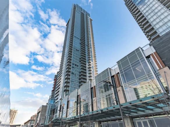 Luxury downtown Vancouver high-rise building with modern glass architecture for real estate investment and condos in BC.
