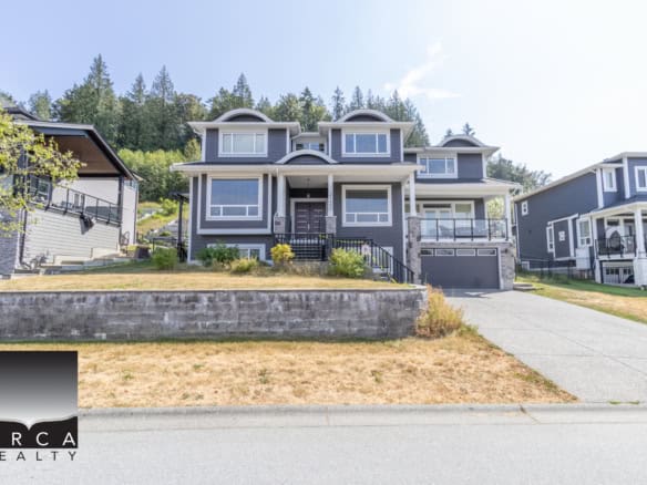 Contemporary multi-level house in a scenic neighbourhood, featuring modern architecture, large windows, and a spacious driveway. Perfect for those seeking premium real estate options in the Orca Realty portfolio.